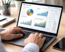 Digital marketer reviewing digital marketing analytics, graphs, and campaign performance on a laptop in a modern office
